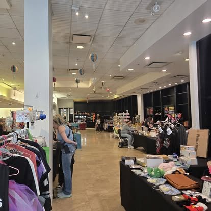 Racks of clothing and vendor tables inside Yorktown Swap